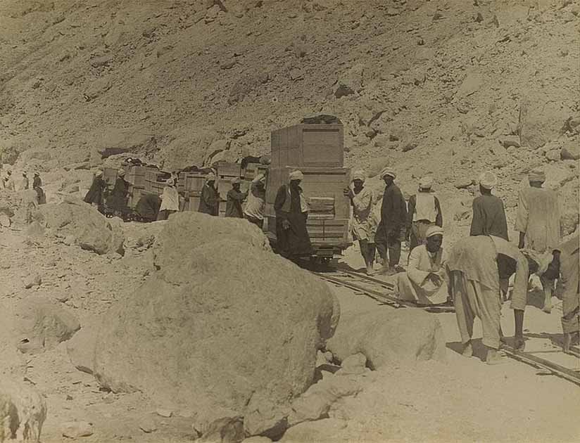 Tomb treasures packed in wooden crates being transported from the tomb to the banks of the Nile for transportation to Cairo by boat. (Public domain)
